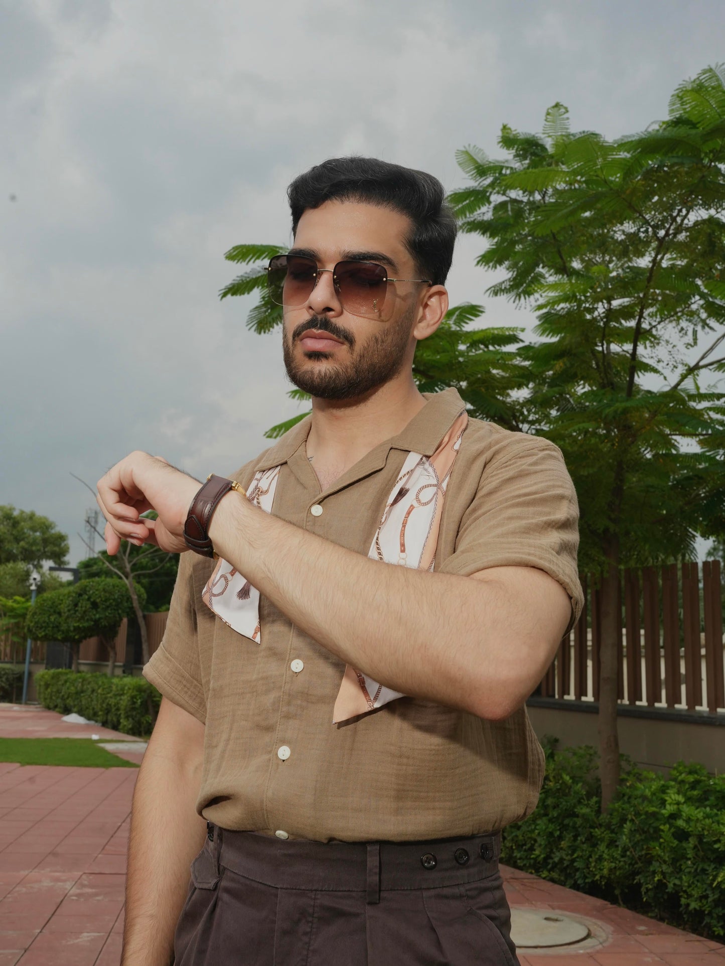 Man wearing sunglasses and a Twilly Scarf